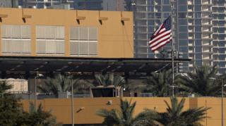 The US flag flutters outside the US Embassy, seen across the Tigris River in Baghdad's fortified Green Zone in March 2026