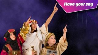 Children dressed as wisemen pointing to a badge that says Have Your Say.