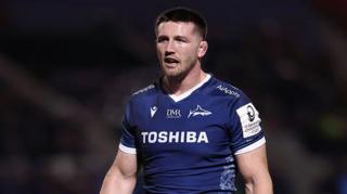 Tom Curry standing on the pitch during Sale v Sharks in the Champions Cup in January