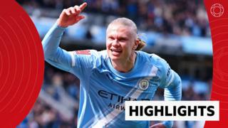Erling Haaland of Manchester City smiles and celebrates his goal with one arm in the air