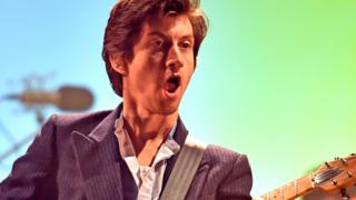 Alex Turner performing with Arctic Monkeys