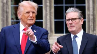 US President Donald Trump and Prime Minister Sir Keir Starmer point at cameras at Chequers during the president's state visit to the UK in September.