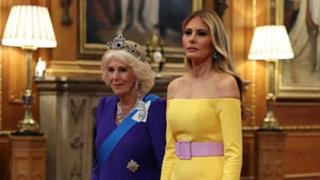 Melania in a yellow dress next to Camilla in a blue dress