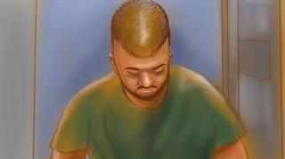 A court sketch of a man with shaved head and green t-shirt with his head bowed.
