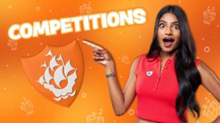 Shini pointing at the world 'Competitions'