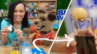 Doctor Leanne and Hacker demonstrate a tooth decay experiment using eggs.