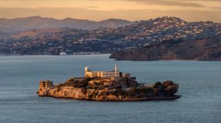 A stock image of Alcatraz prison, showing a building sitting on an island