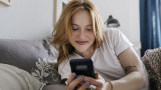 Young women uses her mobile phone