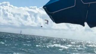 paraglider falling into the ocean