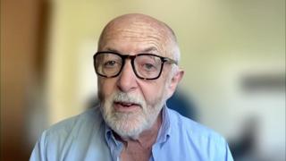 International editor Jeremy Bowen during remote interview wearing light blue shirt