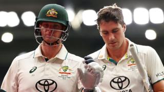 Australia players Steve Smith (left) and Pat Cummins (right) walking off the field