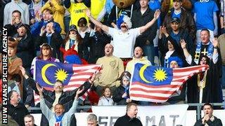 Cardiff fans fly the Malaysian flag