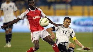 Ahmed Hassan, right, challenges Kenya's Raphael Mungai Kiongera