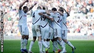 Swansea City celebrate a historic win over leaders Manchester City