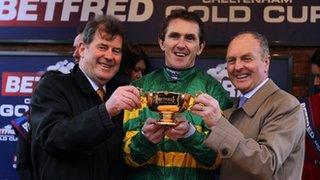 Jockey AP McCoy celebrates with owner JP McManus and trainer Jonjo O"Neill (right)