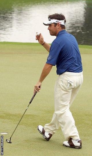 Oosthuizen celebrates after holing his final putt at the Malaysian Open