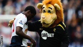 Bolton's Dedryck Boyata with mascot Lofty the Lion