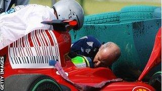 Felipe Massa of Brazil and Ferrari is attended to by Gary Hartstein, medical staff and marshalls following his accident during qualifying for the 2009 Hungarian Grand Prix