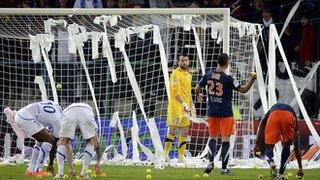 Auxerre's pitch is pelted by tennis balls and toilet rolls