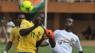 Niger's Ibrahim Adamou (right) vies for the ball with Gabon's Henri Antchouet