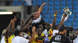 Mali's team celebrate third place at the Nations Cup with coach Alain Giresse