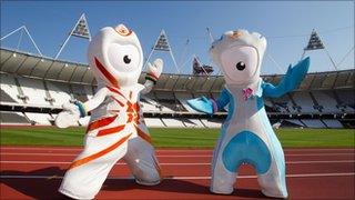 Wenlock and Mandeville stand on the running track of the Olympic Stadium