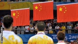 Chinese athletes celebrate a one-two-three in table tennis