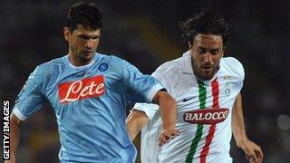 Emilson Cribari is challenged by Luca Toni of Juventus while playing for Napoli