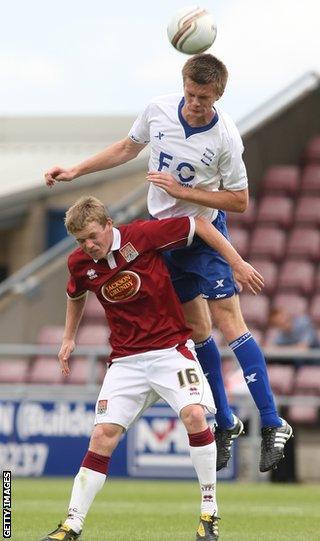 Kerr rises above Northampton Town's Billy McKay during pre-season