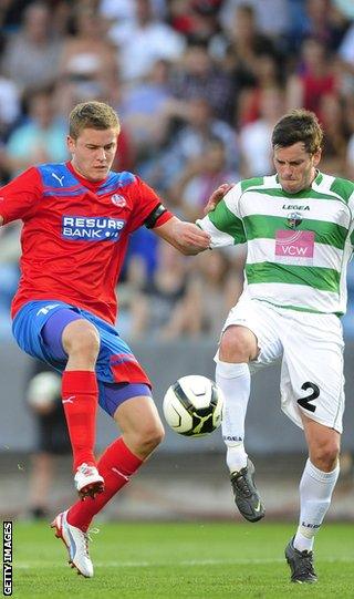 Finnbogason is challenged by New Saints' Simon Spender in the second qualifying round