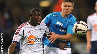 Benik Afobe (l) in action for Bolton Wanderers against Derby