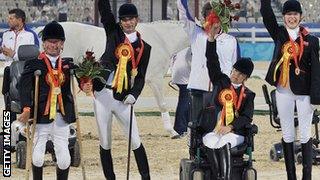 Anne Dunham, Sophie Christiansen, Lee Pearson and Simon Laurens of Great Britain celebrate after winning the Gold Medal of Overall Team at Hong Kong Olympic Equestrian Venue in 2008