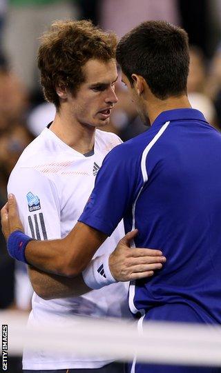 Murray and Djokovic embrace after the Scots' historic victory in New York