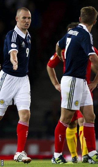 Miller and Morrison celebrate after Scotland's equaliser at Hampden Park