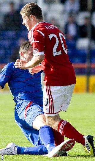 Tudor Jones puts in a heavy challenge against Fraser that leads to a red card