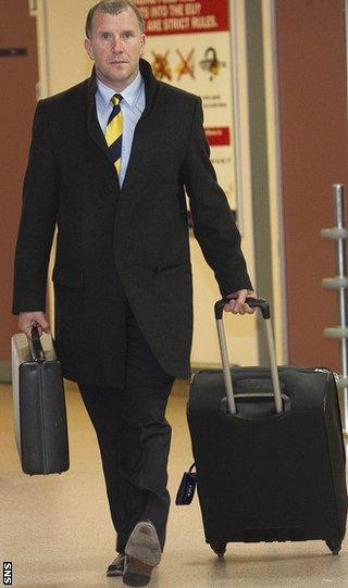 Regan arrives back at Glasgow Airport after the defeat in Brussels