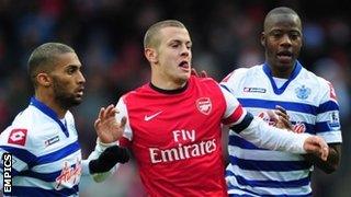 Armand Traore (l) and Samba Diakite (r) track Arsenal's Jack Wilshere