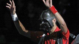 Novak Djokovic arrives on court wearing a Darth Vader mask