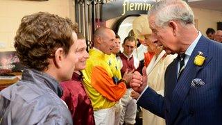 The Duchess of Cornwall and Prince of Wales meet jockeys before the race