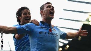 Edin Dzeko (right) celebrates with David Silva