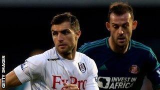 Steven Fletcher (r) challenges Fulham's Aaron Hughes