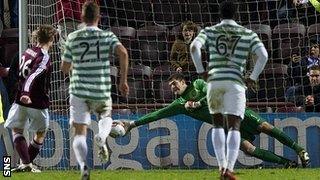 Fraser Forster saves Marius Zaliukas's penalty