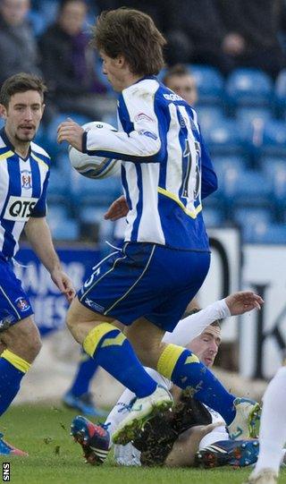 Stephen McKenna slides in on Kilmarnock midfielder Borja