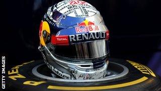 Vettel's helmet resting on a tyre