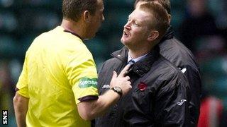 Referee Iain Brines talks with Steve Lomas on the touchline