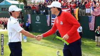 Rory McIlroy greets Keegan Bradley after a dash to make his Ryder Cup tee-off time