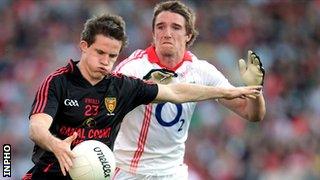 Paul McComiskey battles with Aidan Walsh in the 2011 All-Ireland qualifier