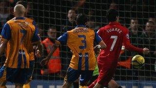 Luiz Suarez turns in the winner for Liverpool against Mansfield