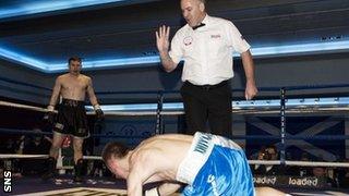 Eddie Doyle struggles to get back on his feet after his second knockdown by Willie Limond