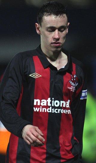 Crusaders winger Paul Heatley trudges off after being red-carded for a 50th minute foul on George McMullan